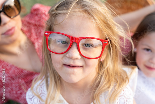 funny portrait of little baby girl wearing vintage colored glasses