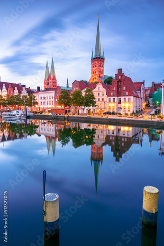 Obraz na płótnie Lubeck, Germany. Cityscape image of riverside Lubeck with reflection of the city in Trave River at sunset. w salonie