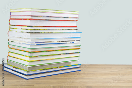 Stack of educational children books and fairy tales on the table, copy space.