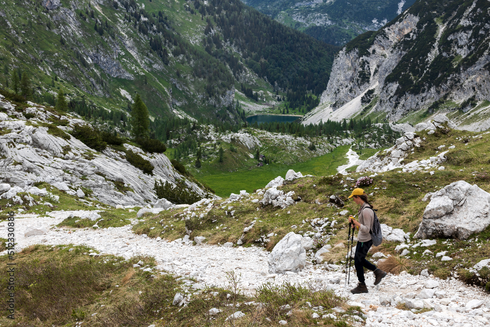 Mid Adult Woman Descending Alpine Trail of Mount Krn in Direction of Lake of Krn - Triglav National Park Slovenia