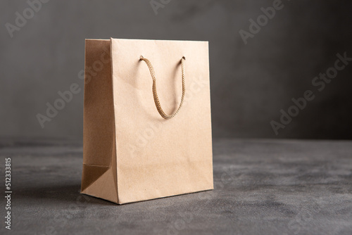 Blank paper carrier bag with handles for shopping - disposable bag, recycling concept