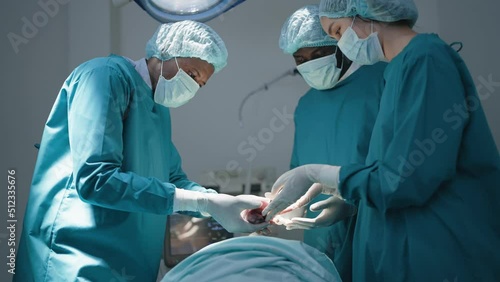 Team of surgeon doctors in operating room undergoing heart transplant surgery for patient to save life in the emergency surgical room. Close up hand doctor holding heart. photo