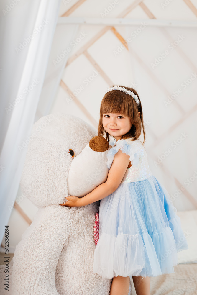 Cute little girl with a huge soft toy