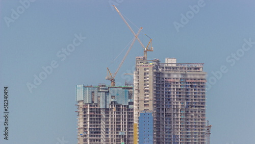 Cranes working on constraction site works of new skyscrapers timelapse photo