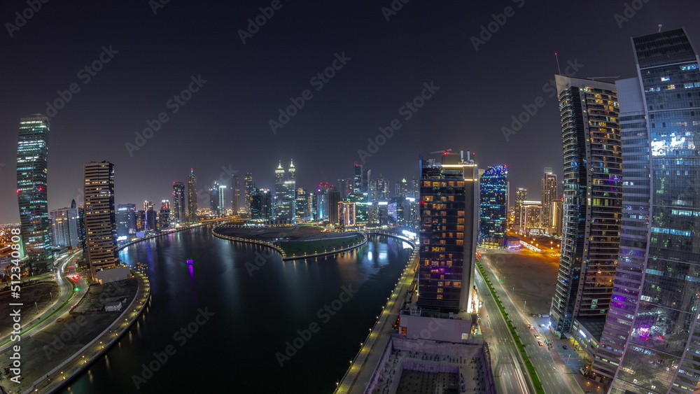 Cityscape panorama of skyscrapers in Dubai Business Bay with water canal aerial night timelapse Cityscape panorama of skyscrapers in Dubai Business Bay with water canal aerial night timelapse