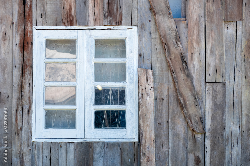 White wooden window on the wall of a vintage wooden house, modern design for relaxation in harmony with nature White wooden window on the wall of a vintage wooden house, modern design for relaxation in harmony with nature