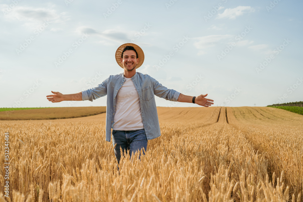 Happy farmer with arms outstretched standing in his growing wheat field. Happy farmer with arms outstretched standing in his growing wheat field.