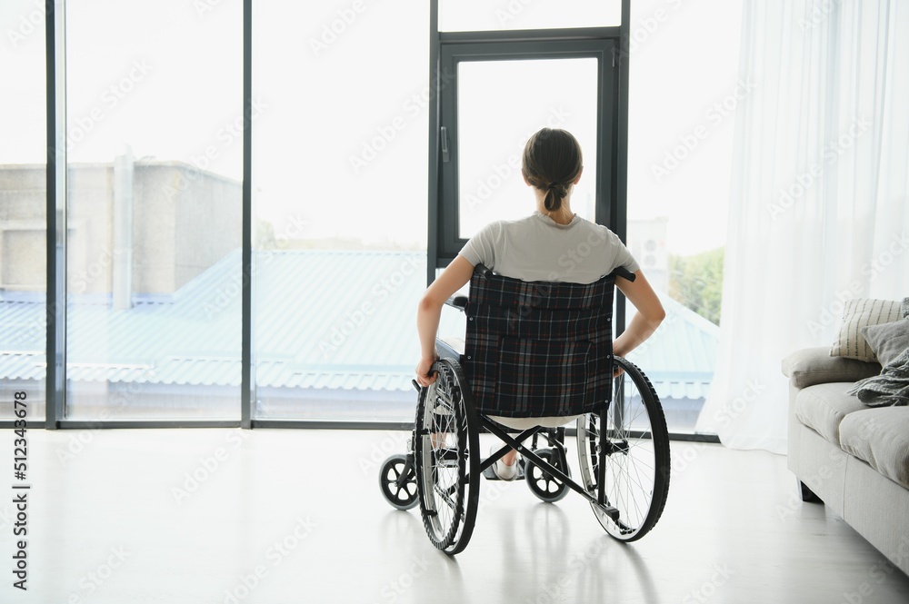 Young woman in wheelchair at home Young woman in wheelchair at home