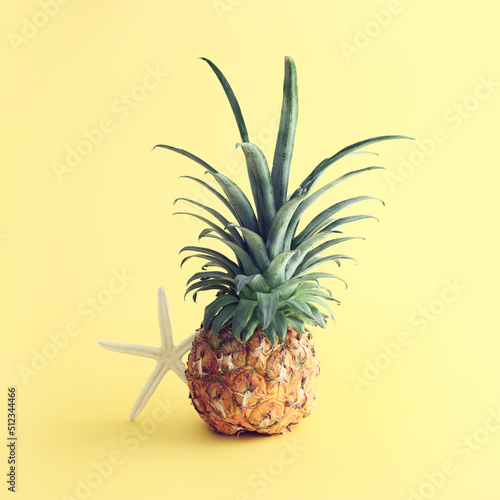 Ripe pineapple over yellow background. Beach and tropical theme