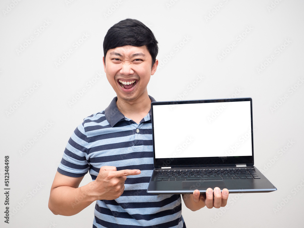 Young man striped shirt satisfied holding laptop white screen isolated Young man striped shirt satisfied holding laptop white screen isolated