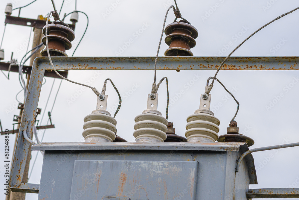 High voltage circuit breaker,insulators and conductors in a power substation.Close up.