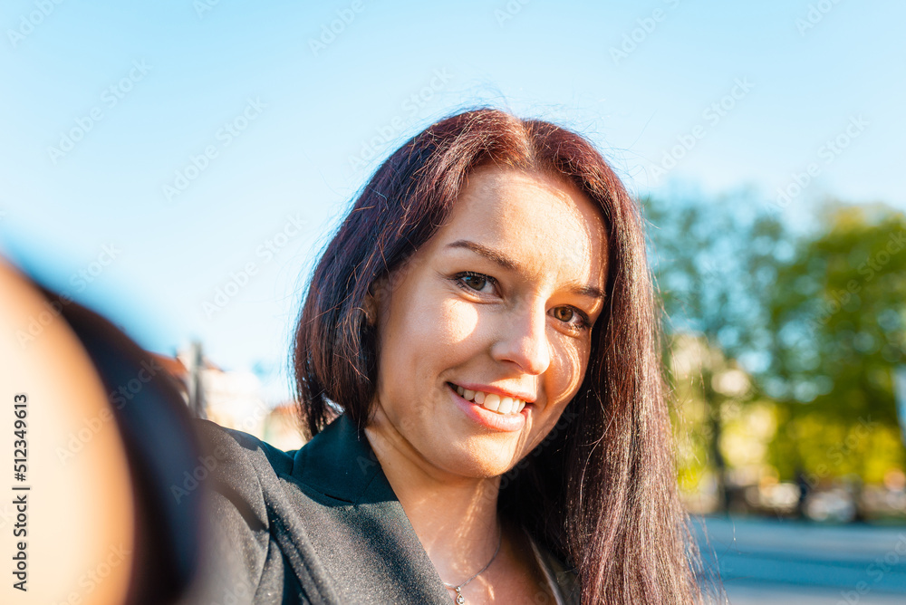 Closeup selfie portrait of attractive girl with long hairstyle and smile in the city.Warm sunset summer evening.Closeup. Closeup selfie portrait of attractive girl with long hairstyle and smile in the city.Warm sunset summer evening.Closeup.