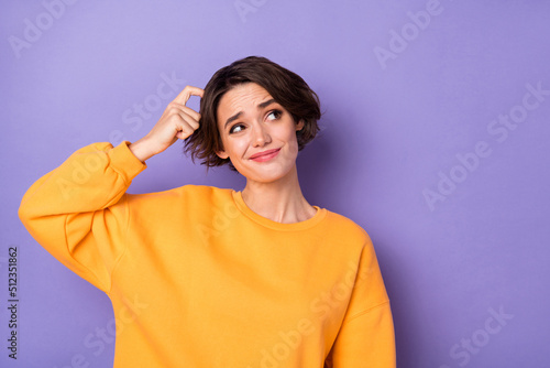 Photo of minded young person arm finger scratch head look interested empty space isolated on violet color background