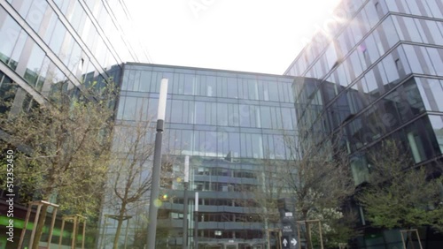 Business hands shaking in front of an office building.