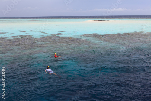 People snorkeling at Filitheyo island, Maldives