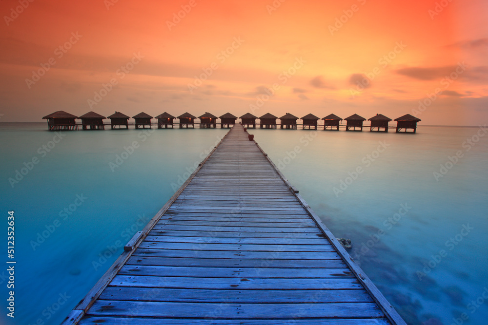 Bungalows and jetty at Filitheyo island, Maldives Bungalows and jetty at Filitheyo island, Maldives