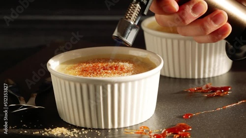 Caramelizing Creme brulee. French dessert.