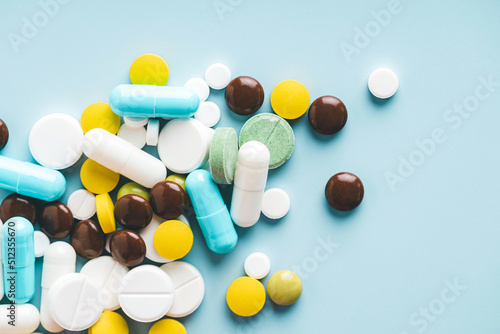 Various pills on blue background, top view. photo