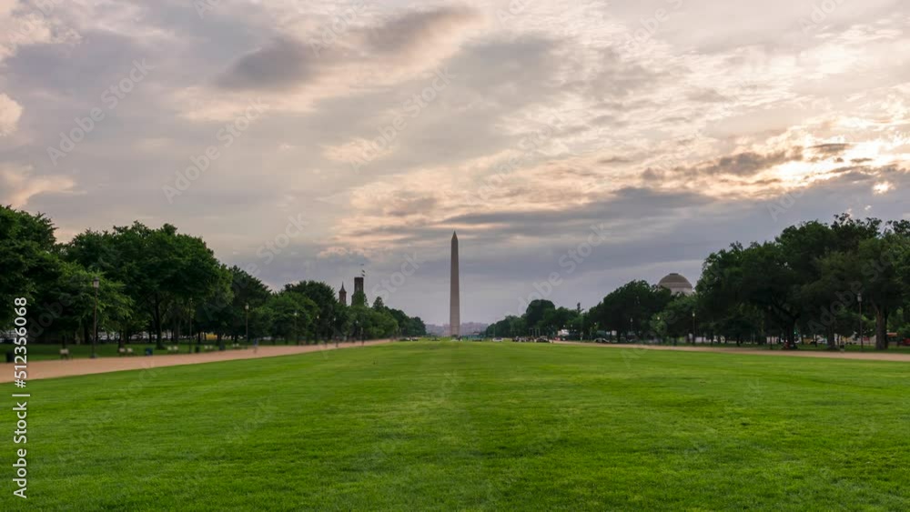 Sunrise Clouds Moving Over the Washington Monument From a Green Lawn Sunrise Clouds Moving Over the Washington Monument From a Green Lawn