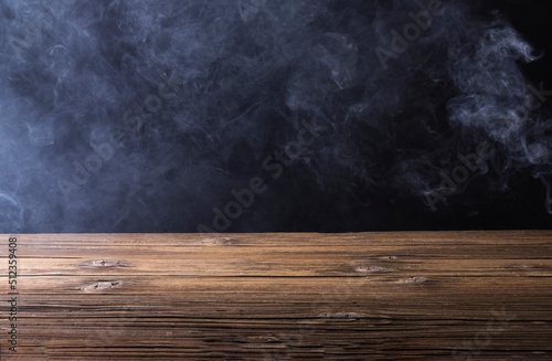 Wooden floor or table with white fog or smoke. on a black background