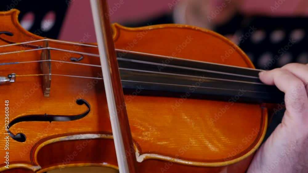 Violinist performing classical music in symphony orchestra, Close-up view