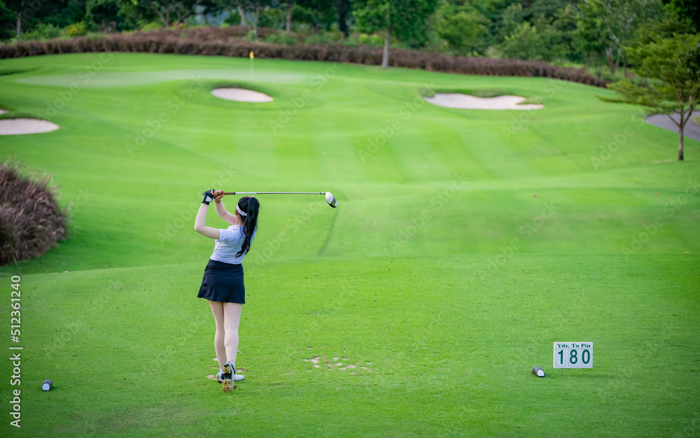 Professional woman golfer teeing golf in golf tournament competition at golf course for winner.	