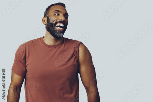 Wallpaper Mural portrait mid adult bearded vaccinated man with plaster on arm laughing looking a
