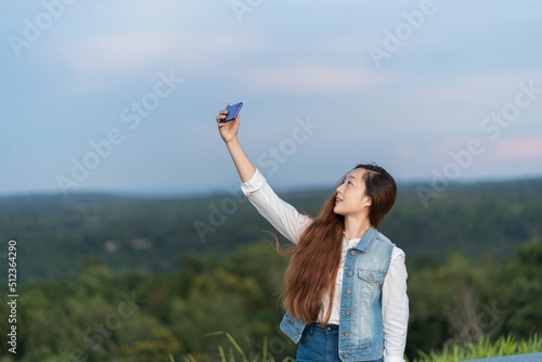 Good mood lady with expansive smile enjoying started weekends and taking selfie on mobile phone at mountain