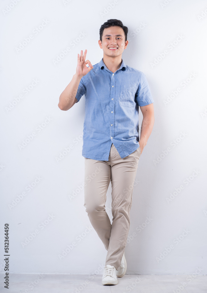 Full length image of young Asian man on white background Full length image of young Asian man on white background