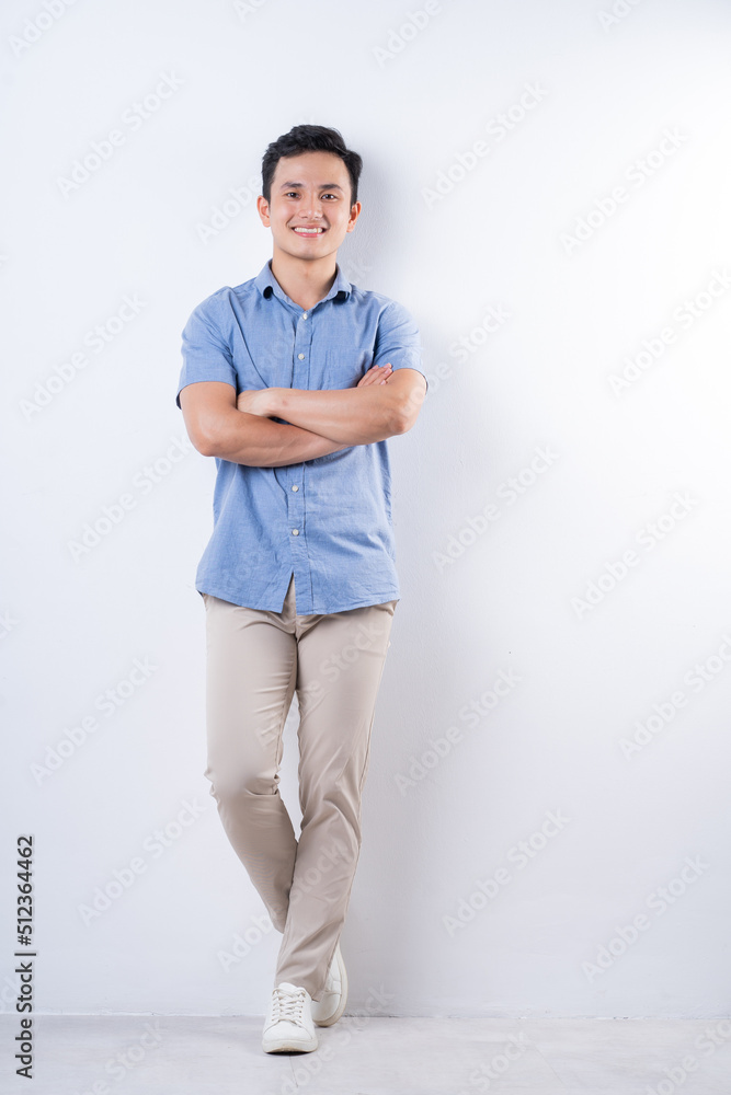 Fototapeta premium Full length image of young Asian man on white background