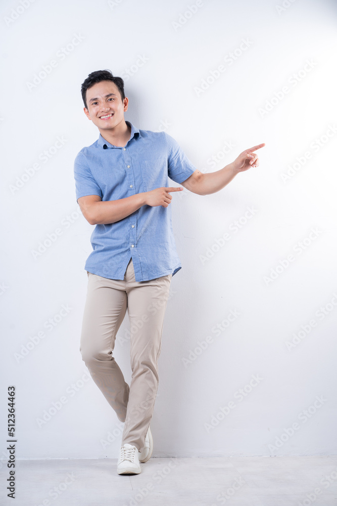 Full length image of young Asian man on white background Full length image of young Asian man on white background