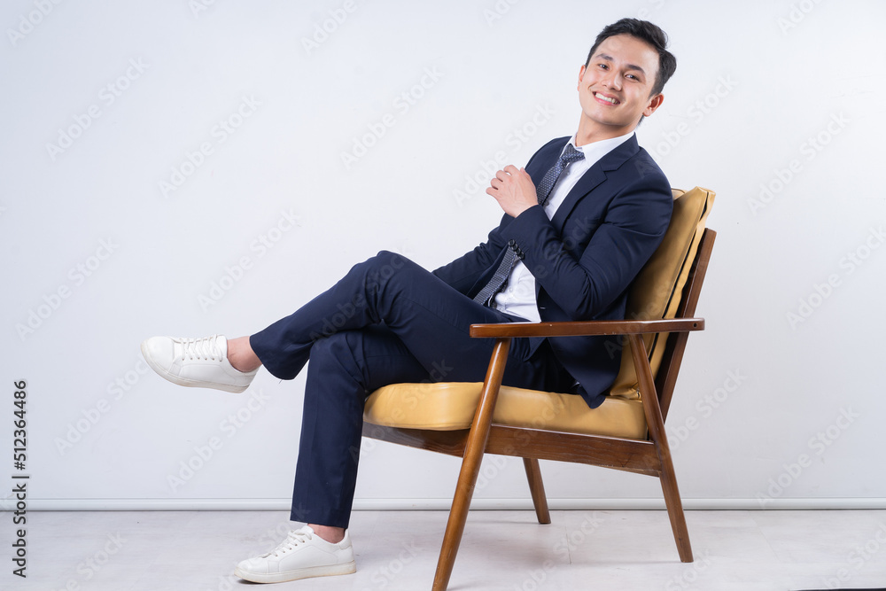 Image of young Asian businessman on background Image of young Asian businessman on background