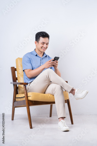 Image of young Asian man sitting on chair