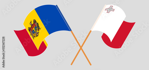 Crossed and waving flags of Moldova and Malta