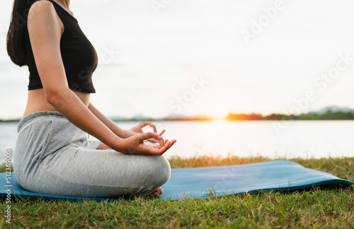 Woman Yoga sitting near river nature sunset
