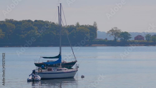 Boats on the water at City Island in New York, with Hart Island in the background. photo