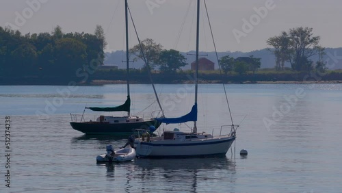 Boats on the water at City Island in New York, with Hart Island in the background. photo