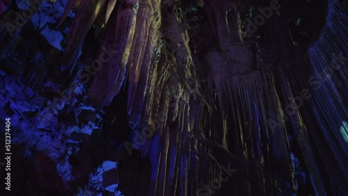 Stalactite rock formations lit by colorful lights, St. Michael's cave.