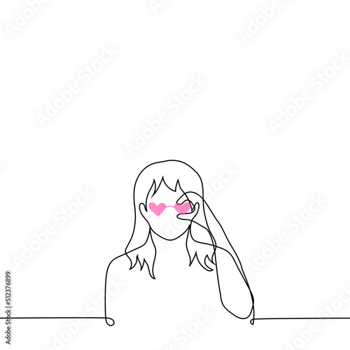 woman or girl puts on pink heart shaped glasses - one line drawing vector. concept to look at world through rose colored glasses (naive view of world), fashionista with glasses in style of 80s, 90s