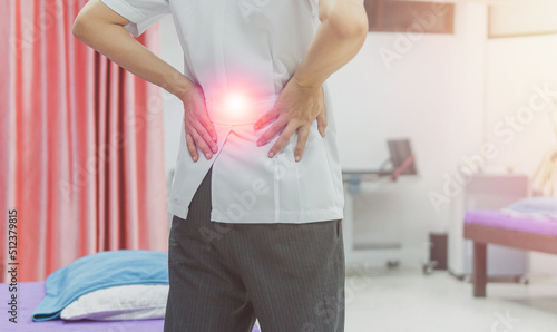 Close up doctor suffering from backpain because overwork, health problem and people concept