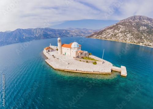 Picturesque island st. George and temple Gospa od Skrpela. Drone view. Boka Kotor Bay, Perast, Montenegro. Ancient Church Crkva Gospa od Skrpjela. Amazing mountain landscape. Beautiful gulf Kotor photo