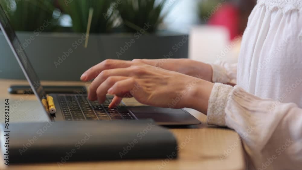 woman in a public place or coworking works on a laptop. video chat talks with colleagues or online dating. a female marketing designer or engineer works online. a european female student watches a woman in a public place or coworking works on a laptop. video chat talks with colleagues or online dating. a female marketing designer or engineer works online. a european female student watches a