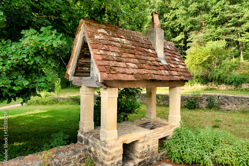 Outdoor barbecue constructed with oak beams, old tiles and stone columns 