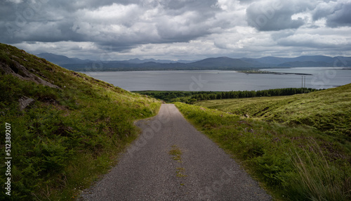 Small rural roadway towards the Atlantic Ocean on the Dingle peninsula, scenic county Kerry in the Republic of Ireland.