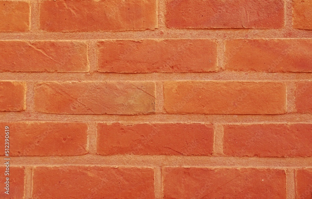 Red brick wall. Background with red stones and red joints. Red brick wall. Background with red stones and red joints.