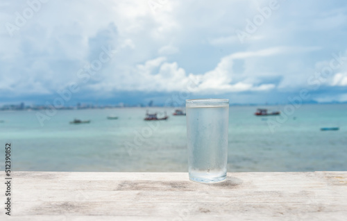 clean and pure drinking, the glass placed on the sea background. healthy drinking glass.