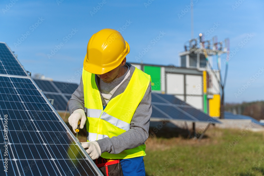 Worker with hard hat and safety equipment installing and working on maintenance of photovoltaic panel system installed on home domestic roof top, urban landscape Worker with hard hat and safety equipment installing and working on maintenance of photovoltaic panel system installed on home domestic roof top, urban landscape
