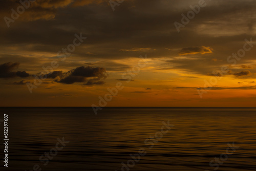 Beautiful sunset background at the beach motion blur.