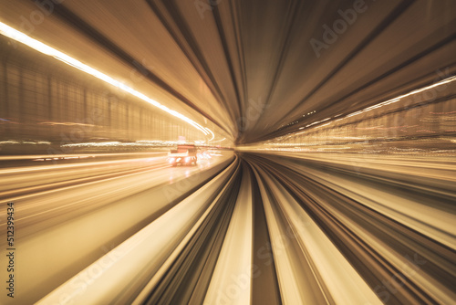 Motion blurred of train moving inside tunnel with daylight in tokyo  Japan. yellow color background concept