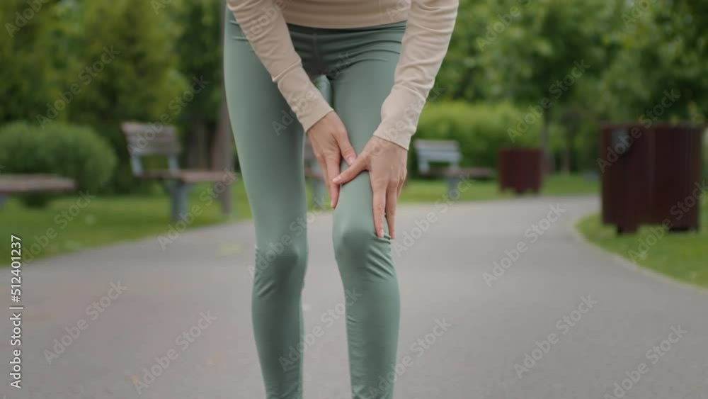 Woman stops from jogging because knee pain, suffers from damage joint problems injury. Foot problems, acute pain. Fitness training health problems. Woman stops from jogging because knee pain, suffers from damage joint problems injury. Foot problems, acute pain. Fitness training health problems.